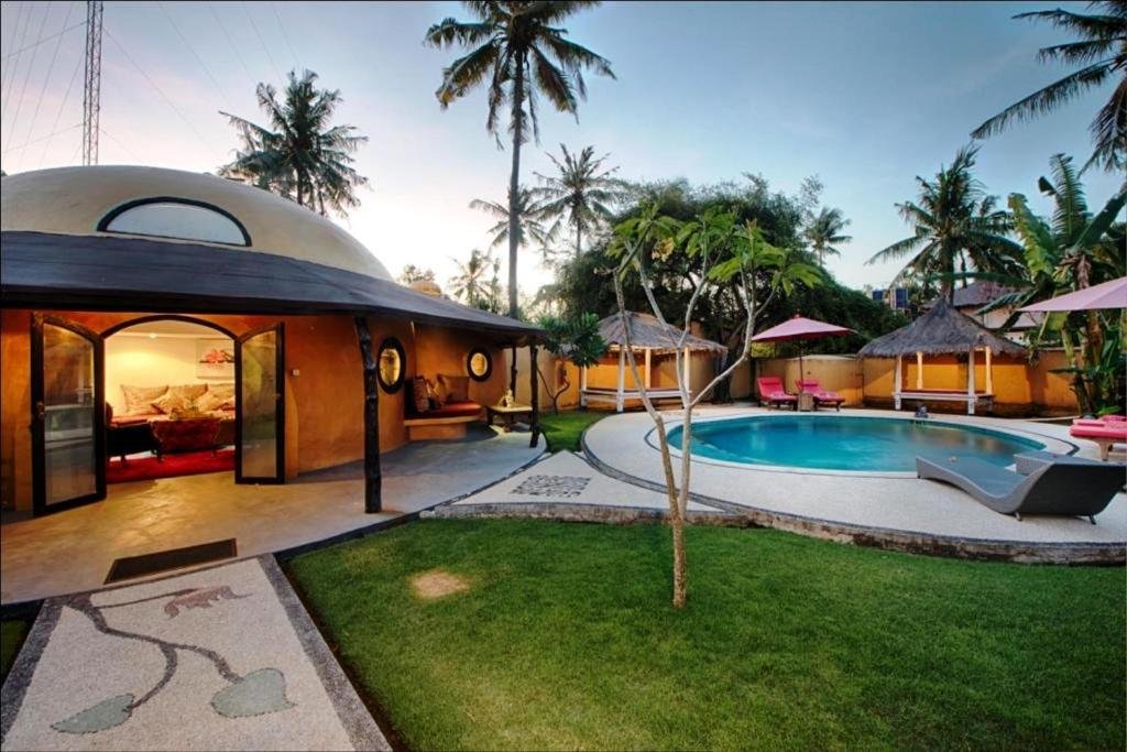 Tropical beachfront pool area at Bel Air Resort and Spa on Gili Air.